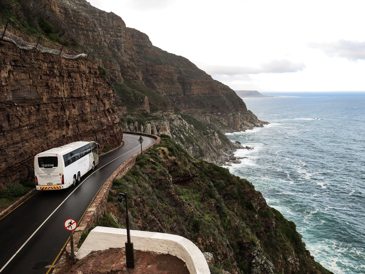 A scenic road trip along dramatic coastal cliffs in South Africa, ideal for travel and adventure.